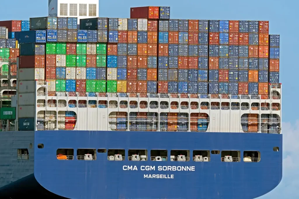 container ship with many containers stacked representing the numerous companies represented on a ship